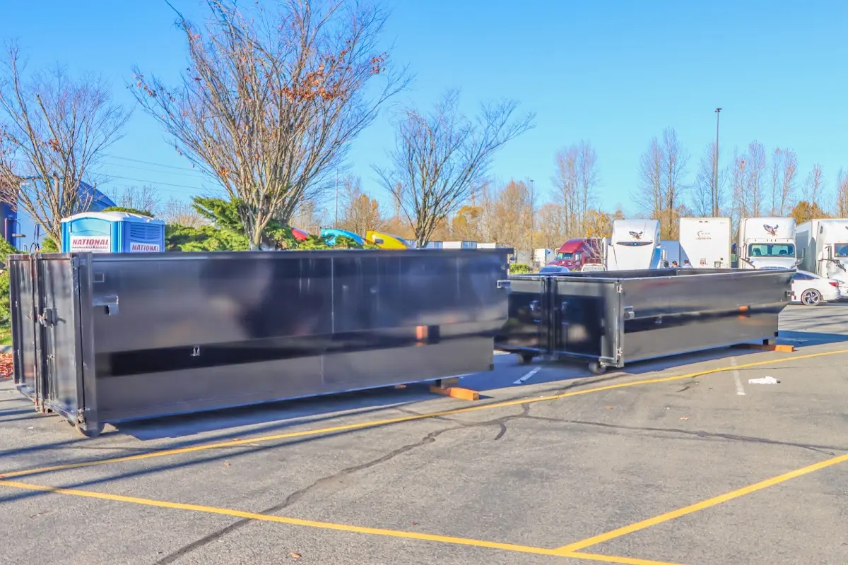 Professional dumpster rental service with roll-off container on residential driveway in Kinnelon